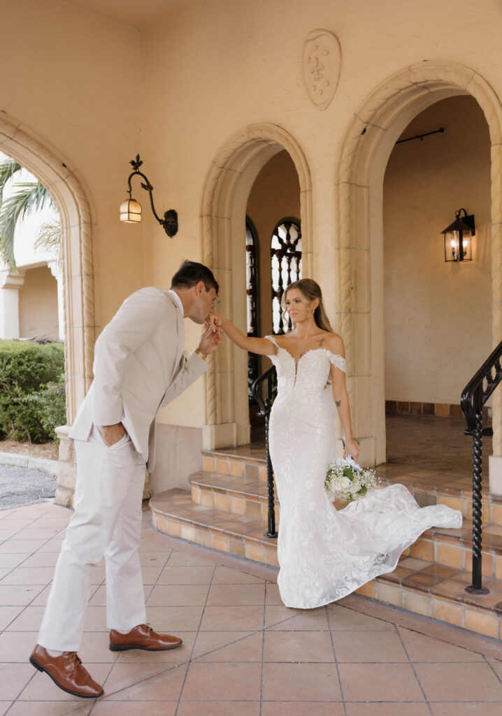 The bride and groom share a quiet moment in front of the historic Powel Crosley Estate, framed by the beautiful architecture